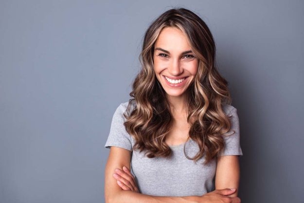 how to get rid of cavities woman smiling widely after learning how to get rid of cavities and prevent tooth decay