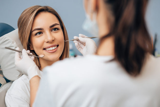 what are dental implants dentist explaining to woman what are dental implants