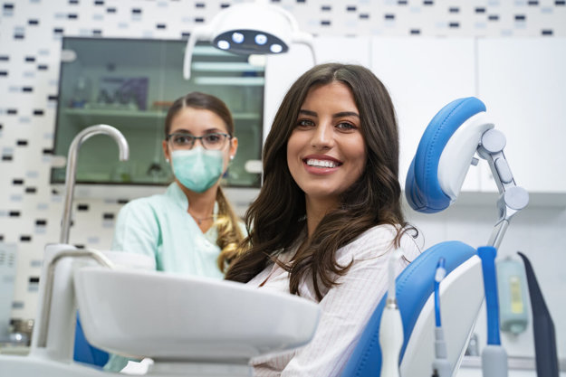 importance of dental care woman smiling at the dentist knowing the Importance of Dental Care