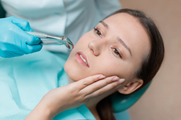 need for wisdom teeth removal woman on anesthesia at the dentist due to the Need for Wisdom Teeth Removal