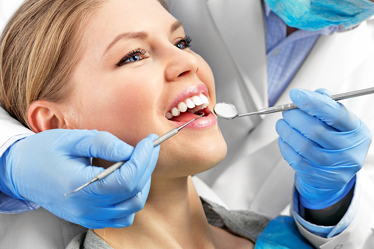 woman getting exam for a dental crown