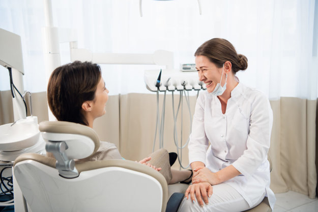 finding a dentist woman talking to hygienist about Finding a Dentist
