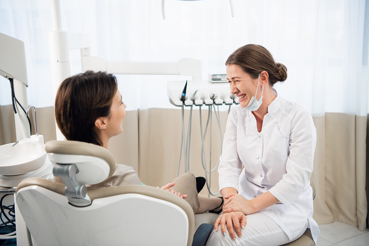 finding a dentist woman talking to hygienist about Finding a Dentist