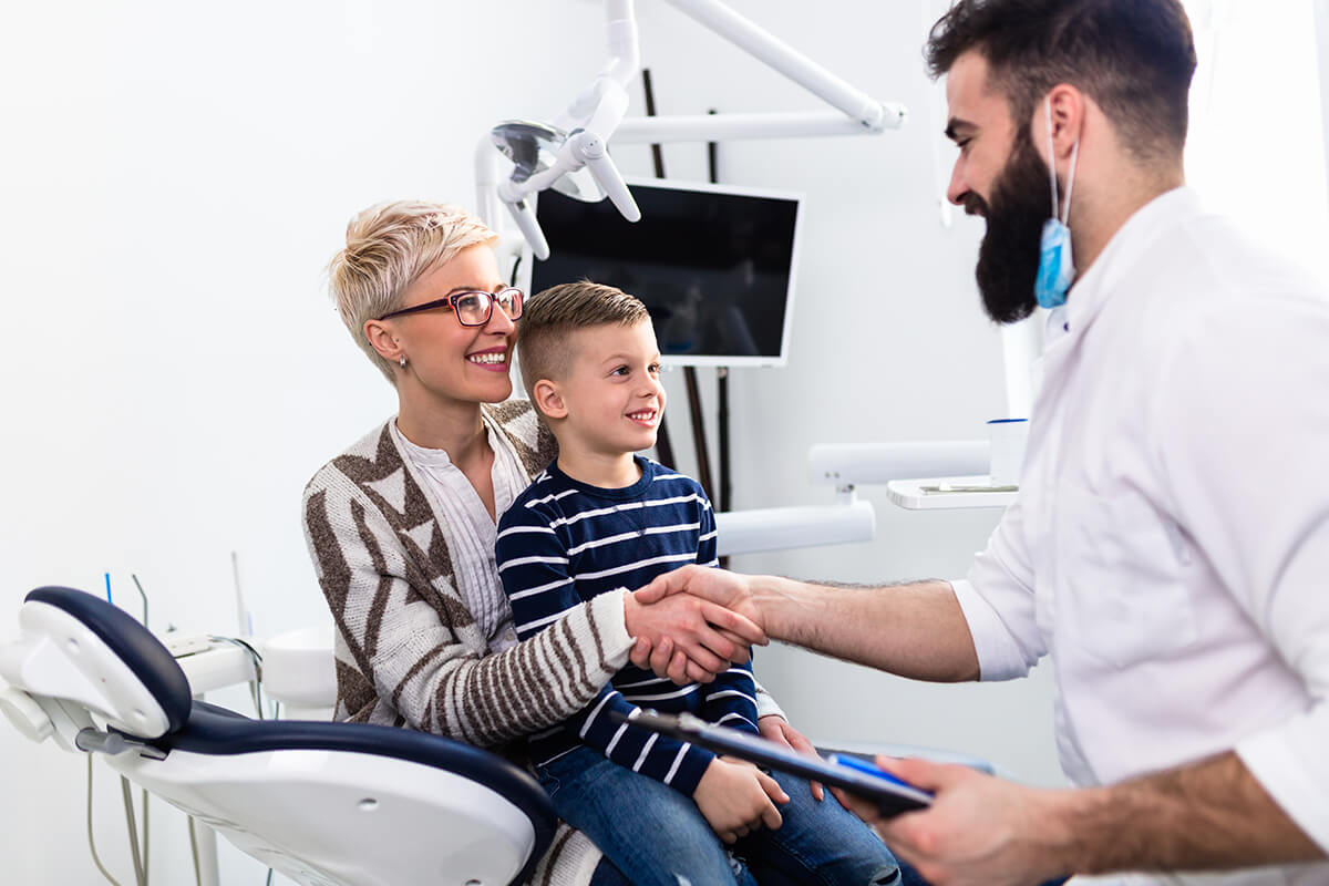 family dentist woman with son meeting Family Dentist