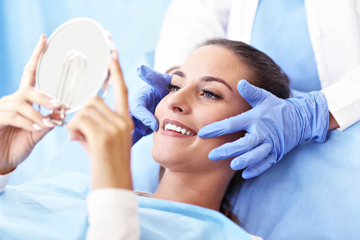 gingivitis treatment a woman at the dentist being shown how to treat gingivitis