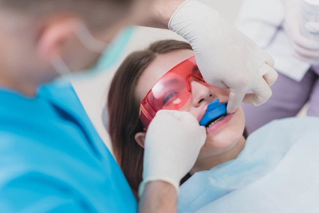 5 things to know about fluoride Young woman receives fluoride treatment