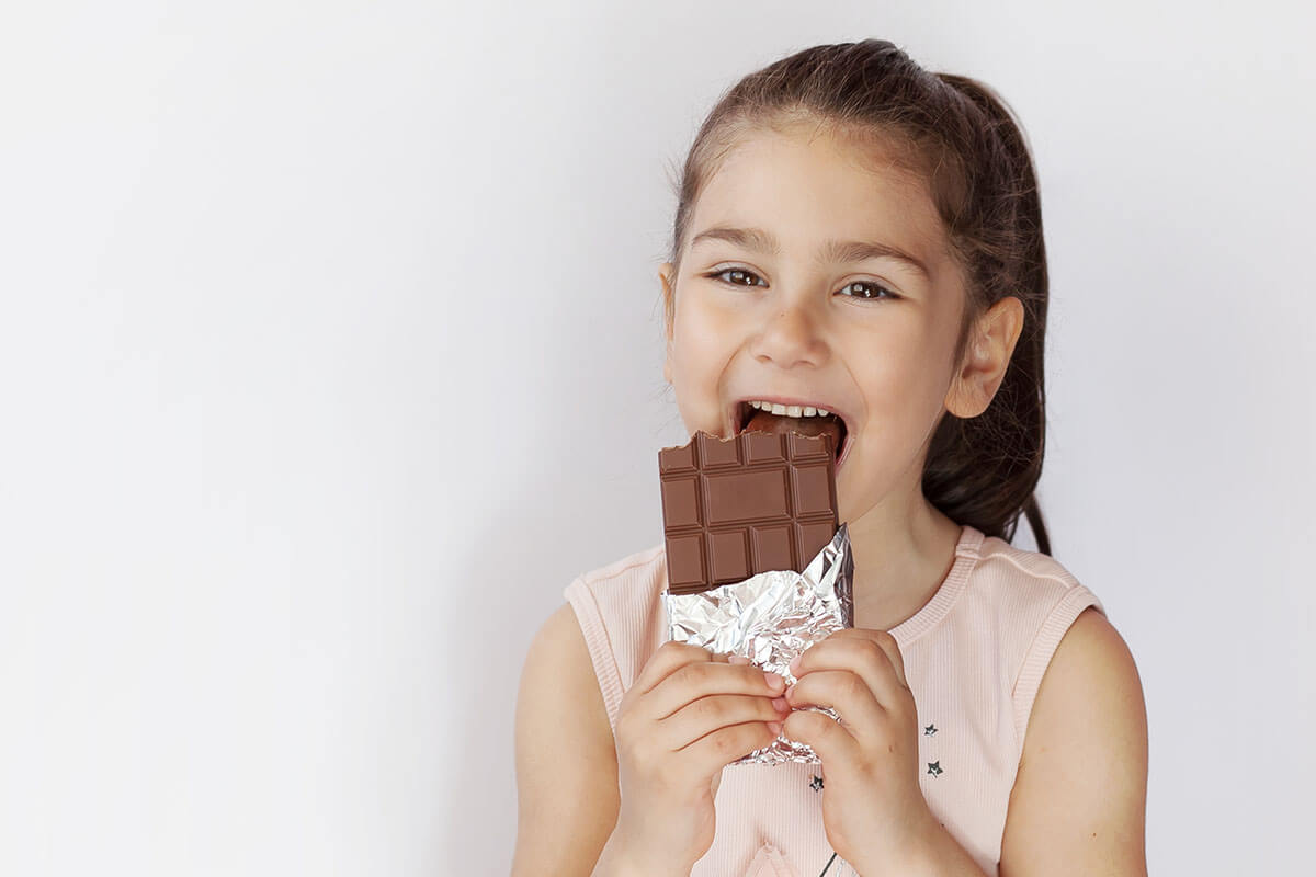 young girl checks on her oral health after holiday sweets