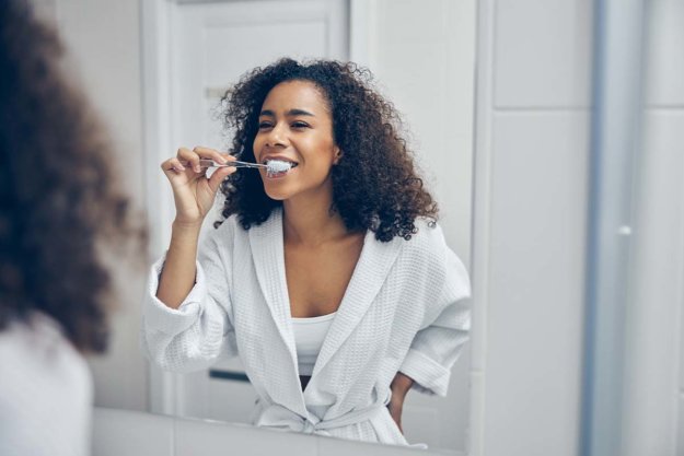 plaque woman brushed teeth to get rid of plaque