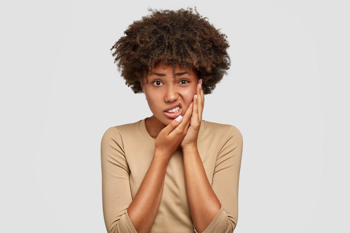 woman considers the causes of her toothache