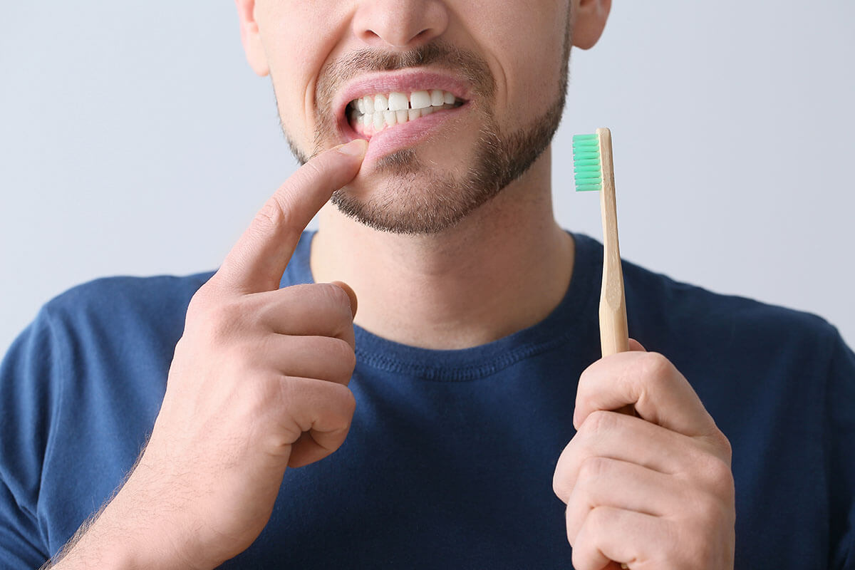 Common Symptoms of Enamel Decay man suffers from symptoms of enamel decay
