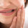girl holding her mouth due to tooth nerve pain