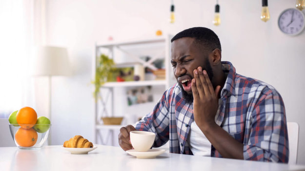 Signs You Need a Root Canal man with tooth pain showing the signs he needs a root canal