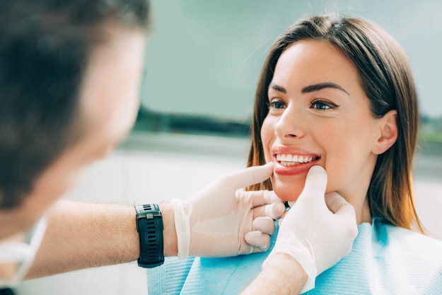 Value of a family dentist woman at dentist learning the value of a family dentist