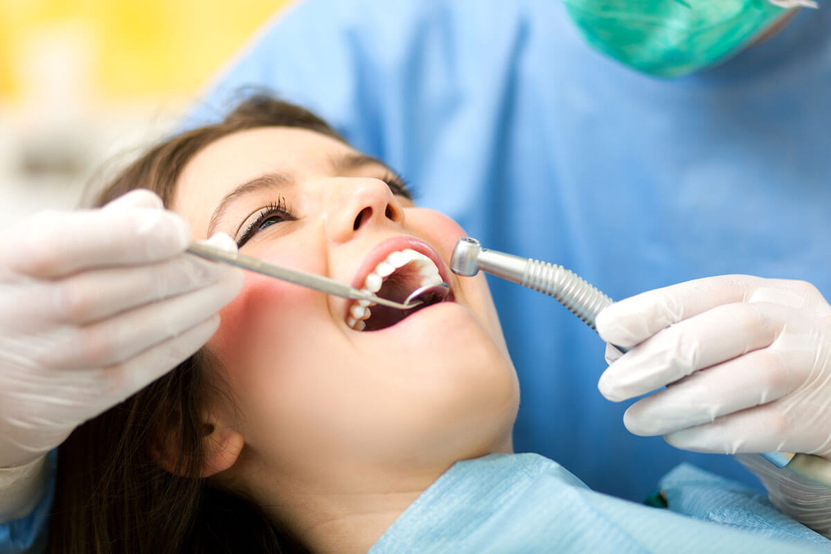 girl smiling while receiving dental sealant