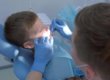 kid in dentist chair getting fluoride treatments for children