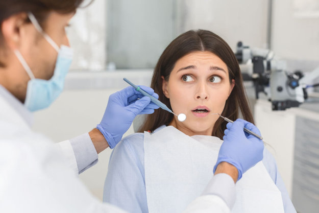 Can Adults Have Dental Anxiety_ woman in dentist office experiencing adult dental anxiety
