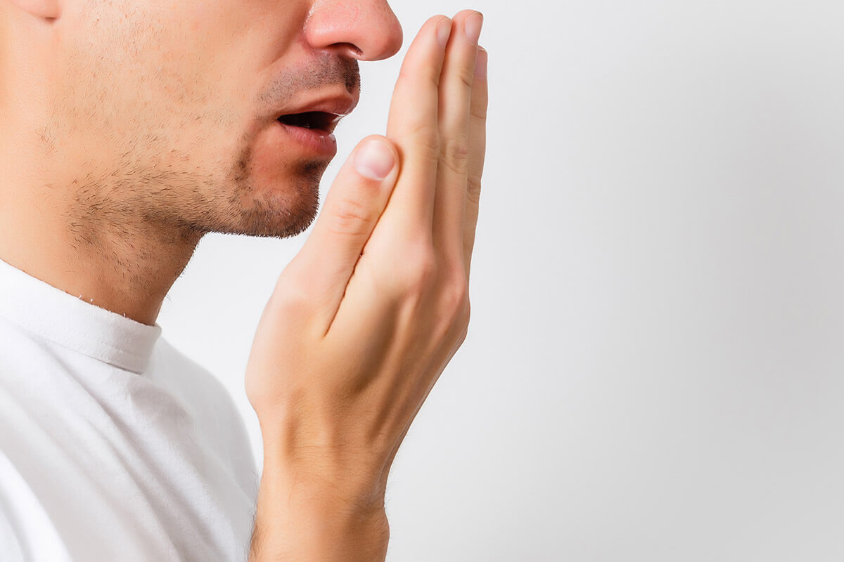 5 Causes of Bad Breath man wonders about the causes of bad breath