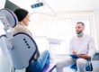 dentist and patient talk about the benefits of dental bridges