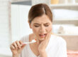 A woman experiencing severe nerve pain in tooth