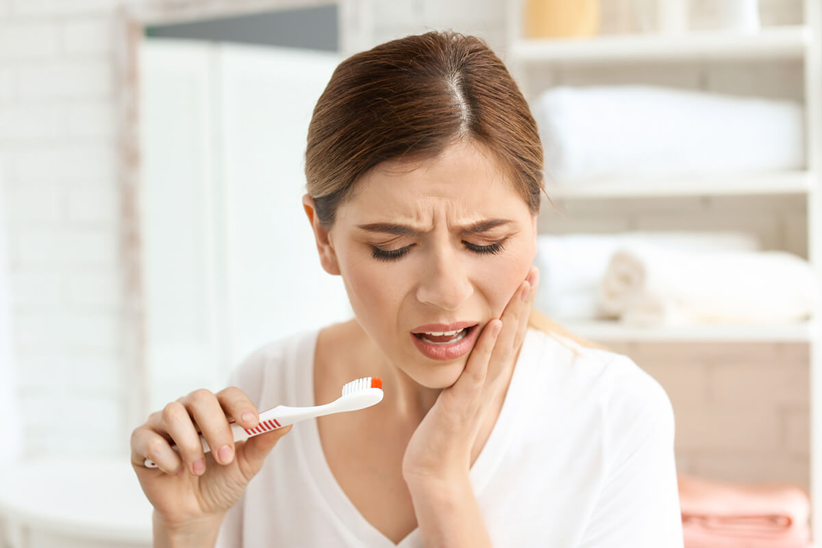 When Does Nerve Pain Signal a Serious Dental Issue A woman experiencing severe nerve pain in tooth