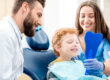 A couple who know the answer to the question, "When should a child first see the dentist?"
