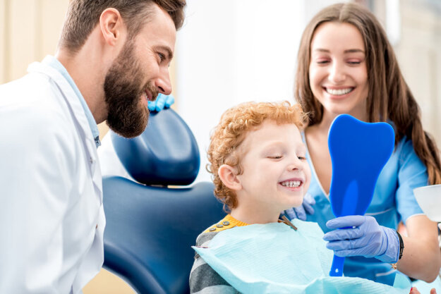 When Should My Child First Visit the Dentist A couple who know the answer to the question, "When should a child first see the dentist?"
