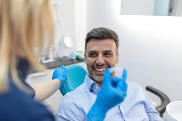 man talks with dentist about the benefits of invisalign