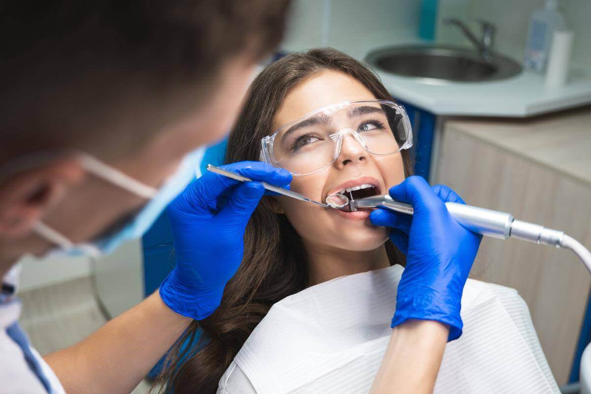 How Long Does a Root Canal Take woman talks with dentist about the time a root canal takes