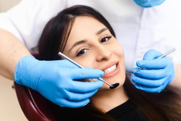 Is Periodontal Treatment Worth It_ woman getting her teeth examined wonders is periodontal treatment worth it