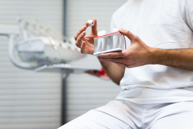Finding Dental Implants in Columbia, MD A dentist demonstrating the process of dental implants