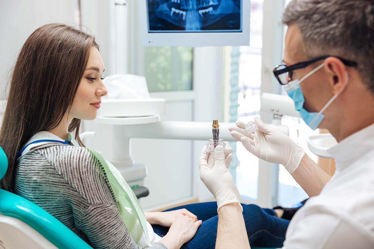 How Much Do Dental Implants Cost A woman wondering about dental implant cost