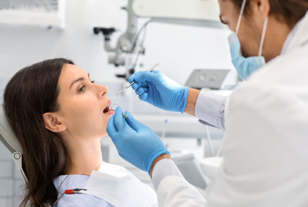 A patient wondering what dental filling cost during a dental visit