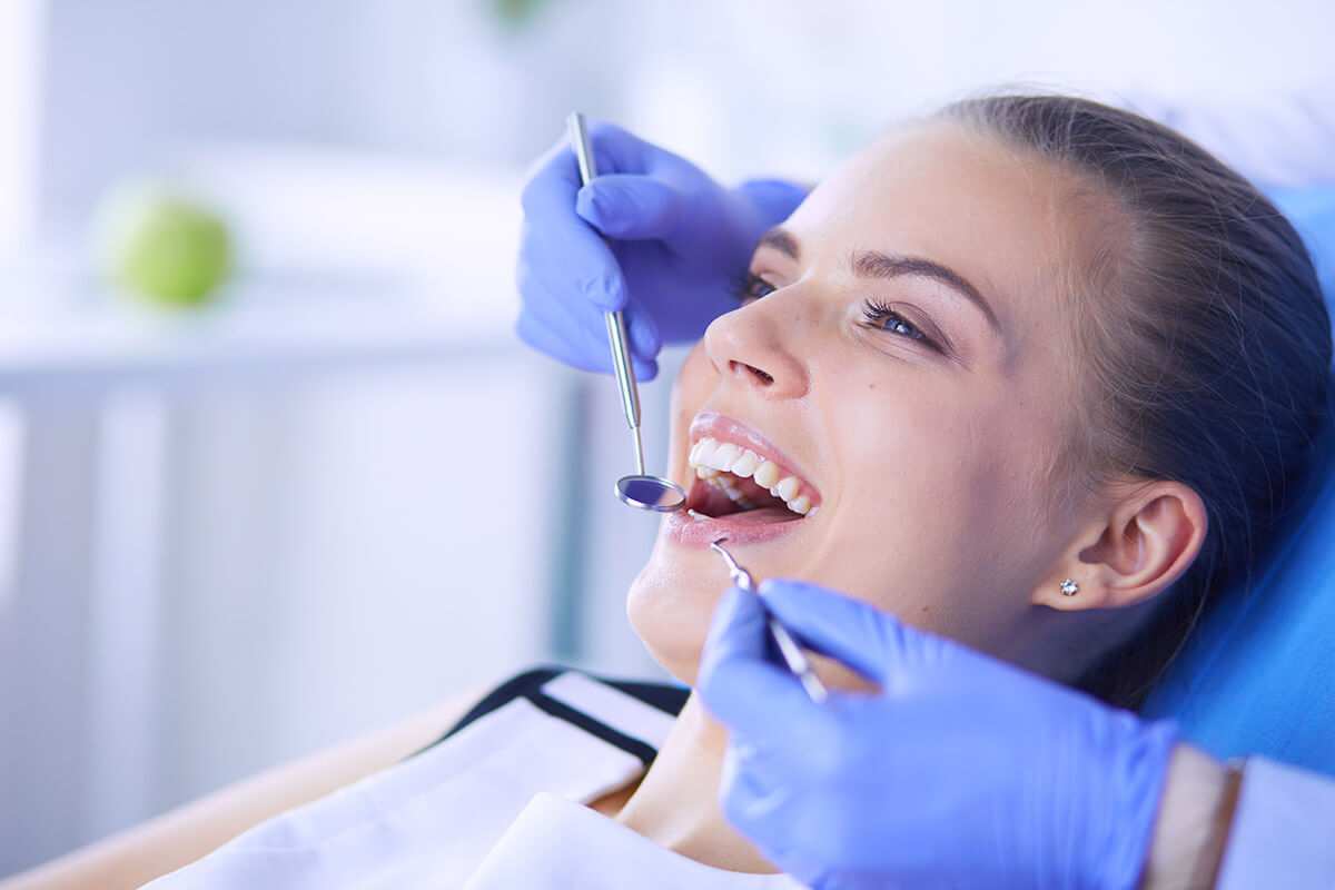 How Much Does Dental Bonding Cost A woman wondering, "How much does dental bonding cost?"