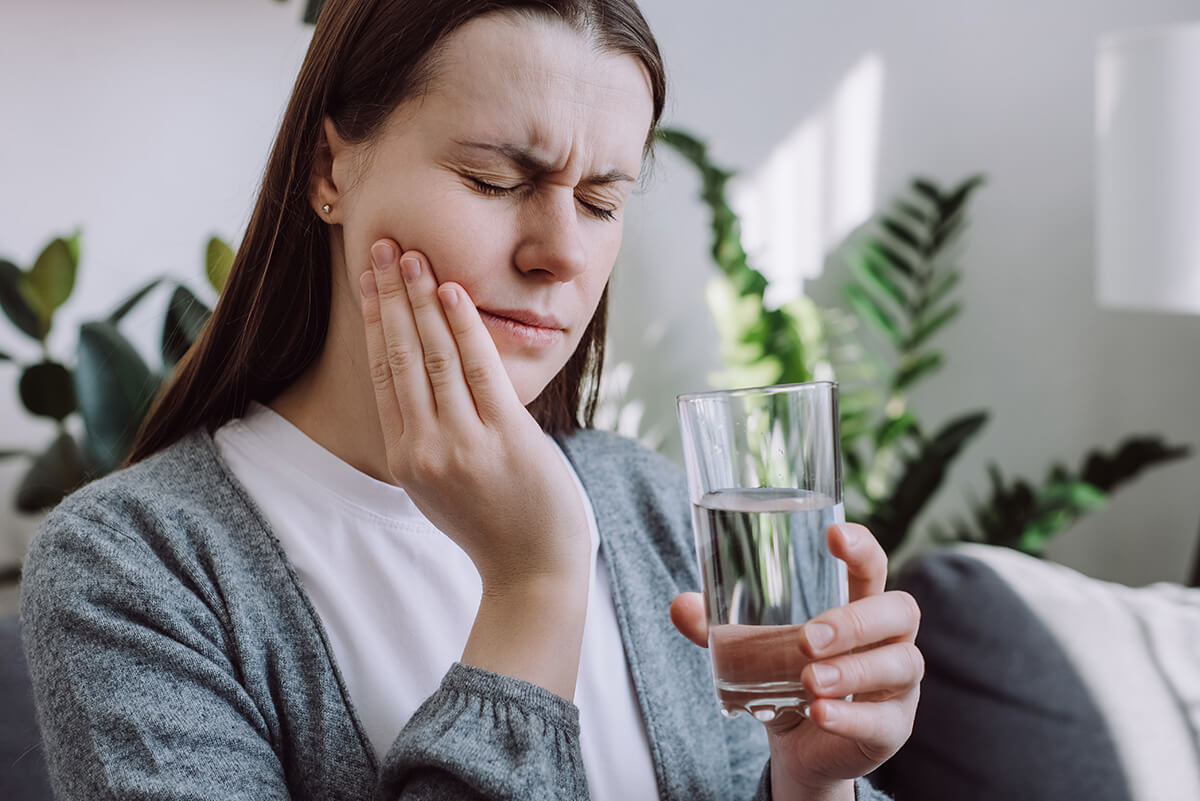 3 Common Reasons for Tooth Pain After a Filling A woman wondering, "Is tooth pain normal after a filling?"