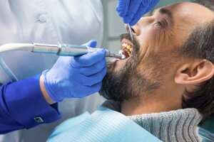 A patient undergoing a teeth cleaning