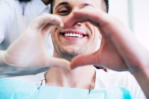 World Oral Health Day- How to Honor Your Smile A dental patient thinking about World Oral Health Day