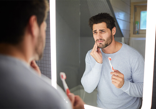 A man experiencing the signs of gum disease