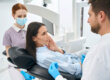 A dentist explains the signs of a dental injury to a patient