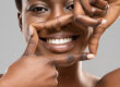 A woman thinking about the fastest way to whiten teeth
