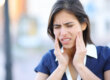 Woman with aching tooth