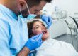 dentist working with patient in chair