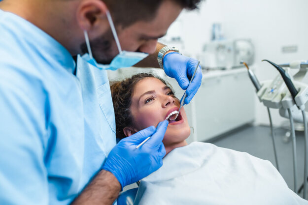 dentist working with patient in chair