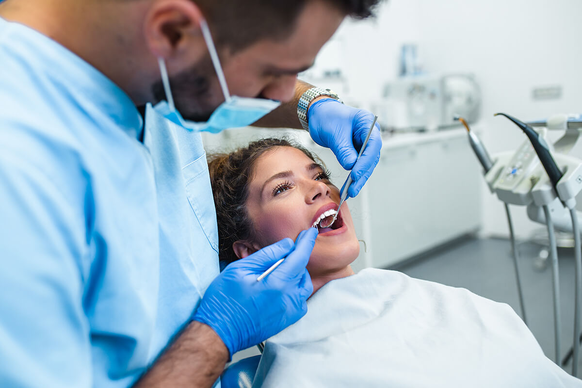 dentist working with patient in chair