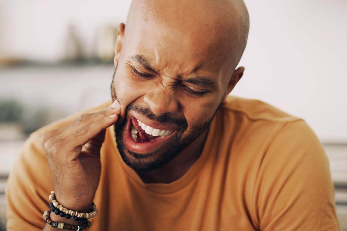 man with wisdom tooth pain